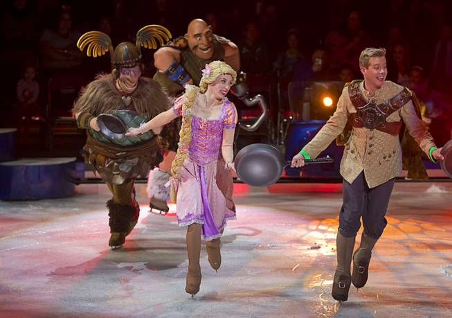 Rapunzel from "Tangled" skates with ruffians as they perform to the song "I Have a Dream" during "Disney On Ice: Rockin' Ever After" at the Thomas & Mack Center Thursday, Jan. 16, 2014. The show plays at the center through Sunday.