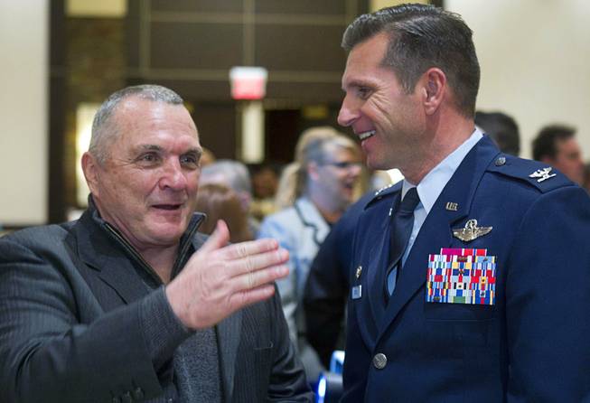 Inspirational speaker Rudy Ruettiger speaks with Air Force Col. Barry Cornish, 99th Air Base Wing Commander at Nellis Air Force Base, after the North Las Vegas State of the City Address at Aliante Casino in North Las Vegas, Jan. 16, 2014.