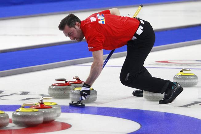 Sebastian Kraupp sweeps in front of a stone during the first day of the 2014 World Financial Group Continental Cup of Curling at the Orleans Arena Thursday, Jan. 16, 2014. Of the twelve teams competing from around the world, nine of them will represent their respective country at the upcoming Olympics in Sochi, Russia.