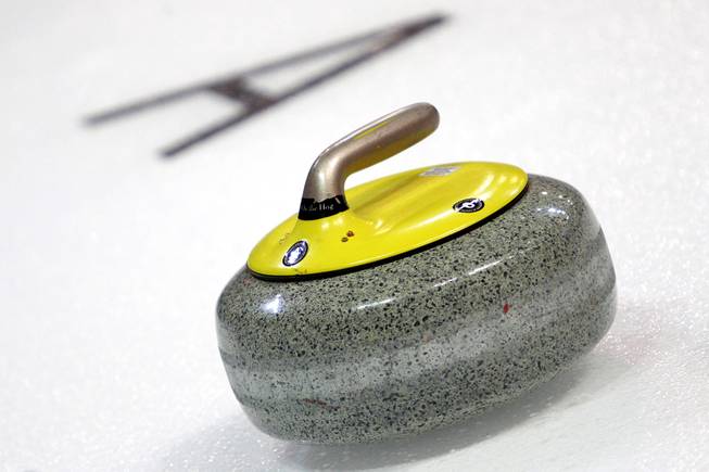 A curling stone is rests on the ice during the first day of the 2014 World Financial Group Continental Cup of Curling at the Orleans Arena Thursday, Jan. 16, 2014. Of the twelve teams competing from around the world, nine of them will represent their respective country at the upcoming Olympics in Sochi, Russia.