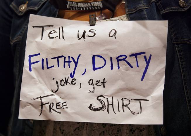 A vendor sports a funny sign around her neck at the AVN Adult Entertainment Expo in the Hard Rock Hotel & Casino on Thursday, Jan. 16, 2014.