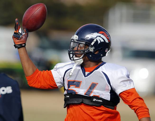 Denver Broncos linebacker Brandon Marshall reaches for a football during practice at the team's training facility in Englewood, Colo., on Jan. 16, 2014. The Broncos will play the Seattle Seahawks on Feb. 2 in Super Bowl 48.