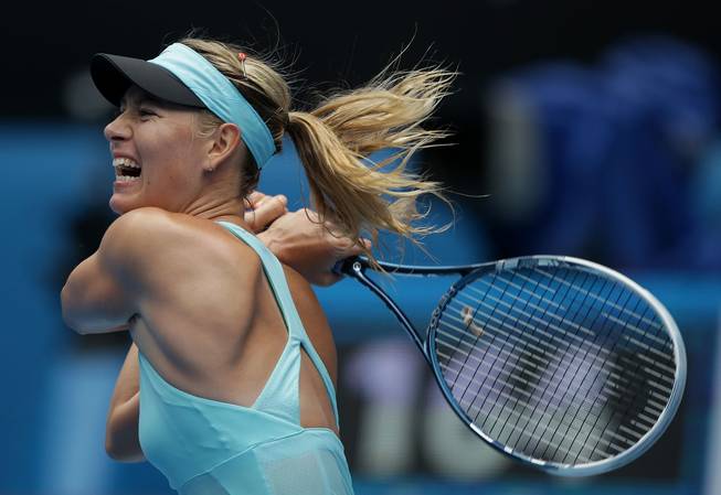 Maria Sharapova of Russia hits a backhand return to Alize Cornet of France during their third-round match at the Australian Open on Saturday, Jan. 18, 2014, in Melbourne, Australia.
