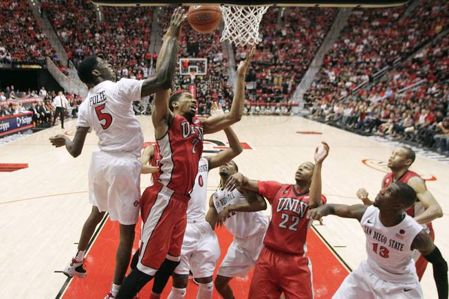UNLV forward Khem Birch and San Diego State forward Dwayne Polee fight for a rebound during their game Saturday, Jan. 18, 2014 at Viejas Arena in San Diego. The 10th ranked SDSU won the game 63-52.