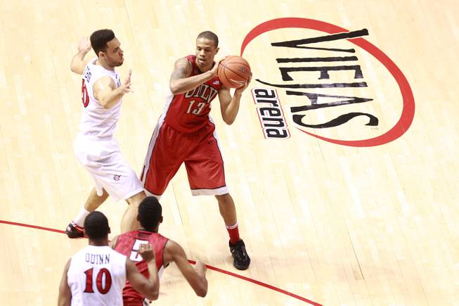 UNLV guard Bryce Dejean Jones is defended by San Diego State forward J.J. O'Brien as he passes to forward Chris Wood during their game Saturday, Jan. 18, 2014 at Viejas Arena in San Diego. The 10th ranked SDSU won the game 63-52.