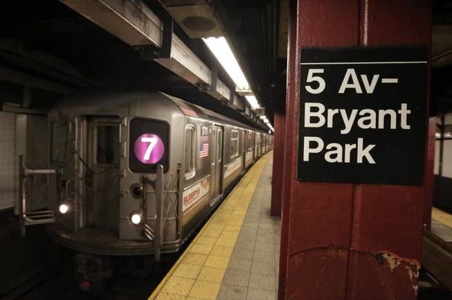 In this Dec. 4, 2013, photo, a No. 7 New York City subway train arrives in the 5th Avenue-Bryant Park station in New York. Noise from screeching subway trains can be overwhelming, sometimes rising up out of the caverns trains operate in and into the buildings above.