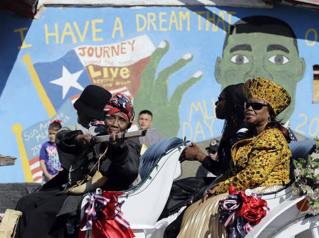 Women dressed in costume take part in a march honoring Martin Luther King Jr., Monday,  Jan. 20, 2014, in San Antonio. Parades and celebrations have been scheduled across Texas to honor Martin Luther King Jr. on the federal holiday in his name. 