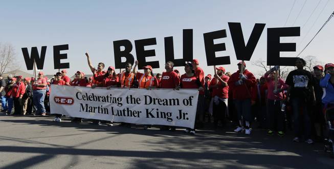 Letters spelling "We Believe" are carried by a group during a march honoring Martin Luther King Jr., Monday,  Jan. 20, 2014, in San Antonio. 