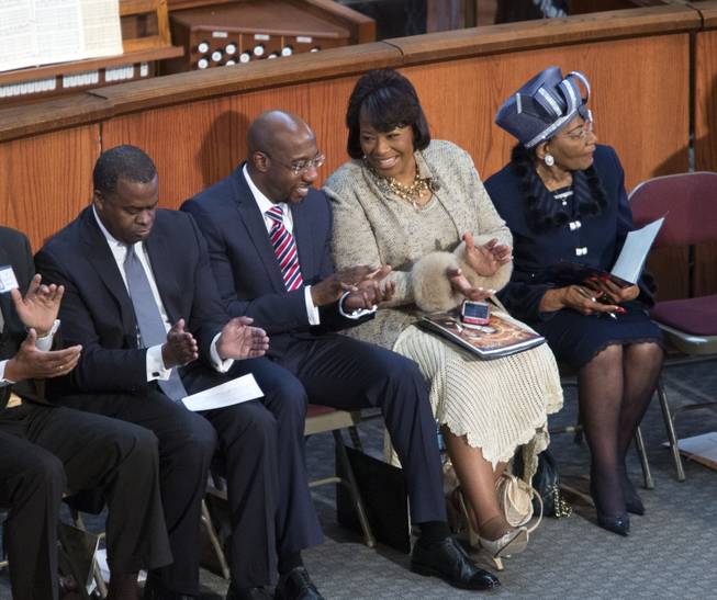 Bernice King, second from right, talks with pastor Raphael Warnock, second from left, during the Rev. Martin Luther King Jr. holiday commemorative service at Ebenezer Baptist Church Monday, Jan. 20, 2014, in Atlanta. Bernice King is the daughter of the late Dr. Martin Luther King Jr., and Christine King Farris, right, is the only living sibling of the late Dr. Martin Luther King Jr.. Also pictured is Atlanta mayor Kasim Reed, left. 
