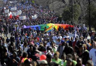 Thousands participate in a march honoring Martin Luther King Jr., Monday,  Jan. 20, 2014, in San Antonio.  Parades and celebrations have been scheduled across Texas to honor Martin Luther King Jr. on the federal holiday in his name.