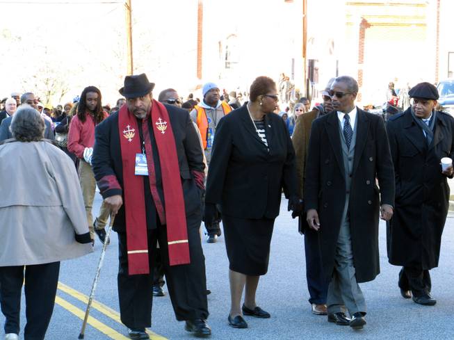 North Carolina NAACP President William Barber, left, interim national  NAACP President Lorraine Miller, center, and South Carolina NAACP President Lonnie Randolph, right, march to the South Carolina Statehouse as part of the King Day at the Dome rally on Monday, Jan. 20, 2014, in Columbia, S.C. 
