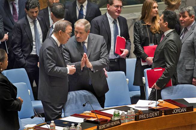 Jordanian Foreign Minister and President of the United Nations Security Council Nasser Judeh, right, has a conversation with U.N. Secretary-General Ban Ki-moon as the Security Council meeting began at U.N. headquarters, Monday, Jan. 20, 2014. 
