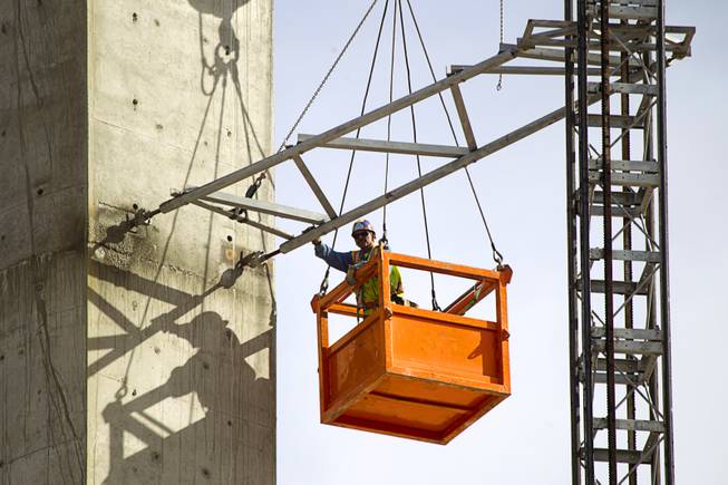 A worker removes scaffolding from the SkyVue observation wheel construction site on the Las Vegas Strip near Mandalay Bay Tuesday Jan. 21, 2014. David Gaffin, a Skyvue developer, wrote in an email that work is continuing on the project but that the scaffolding is not needed at this time.