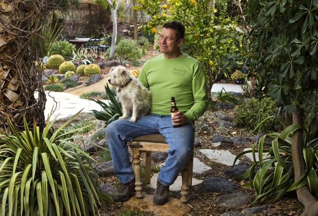 Horticulturalist Norm Schilling relaxes at the end of the day with Buckwheat his dog and a beer in one of his favorite backyard spots at their home on Tuesday, Jan. 21, 2014.