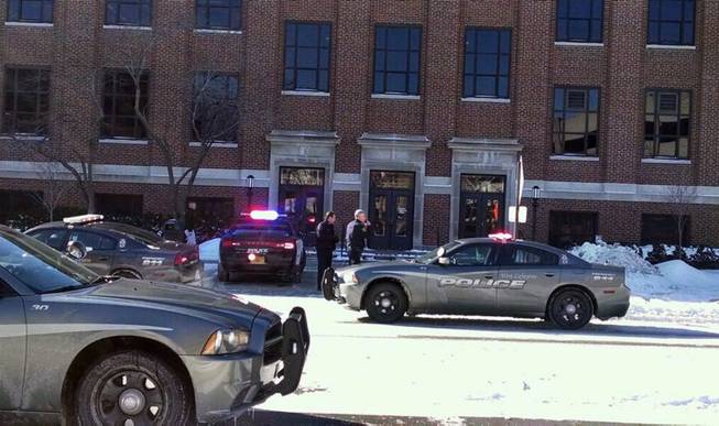 Police investigate a reports of a shooting at Purdue University in West Lafayette, Ind., on Tuesday, Jan. 21, 2014. Police say they have a person in custody and the university says it told people to take shelter and have cleared the building as the area is searched.