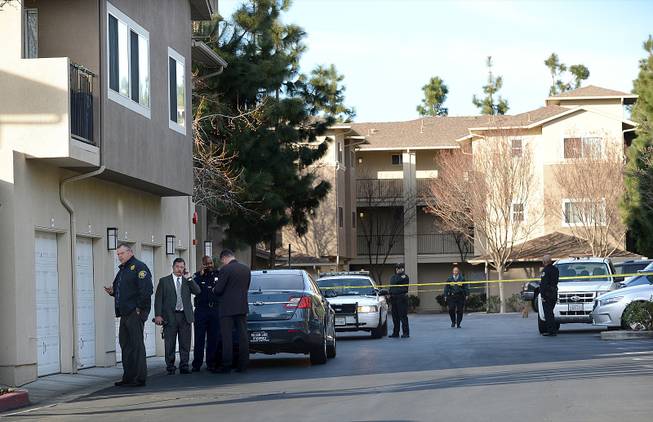 Law enforcement officers investigate the accidental fatal shooting of a Bay Area Rapid Transit police officer by a fellow BART officer while serving a warrant at an apartment building, according to officials, Tuesday, Jan. 21, 2014, in Dublin, Calif. 