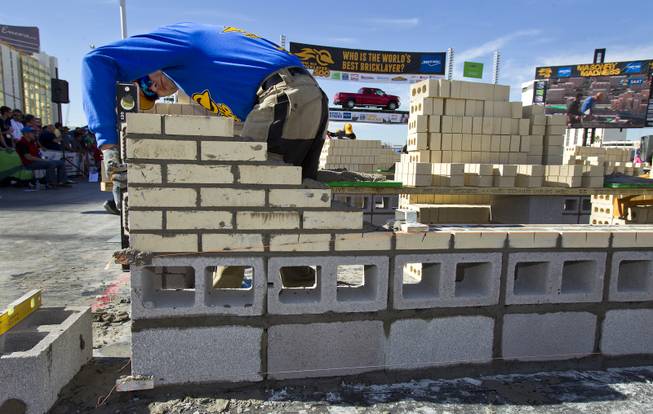 Steve Cleveland of Mundelein, IL., check the straightness of his first bricks laid during the Spec Mix "Bricklayer 500"   competition at the 40th anniversary of the World Of Concrete event outside the Las Vegas Convention Center on Wednesday, Jan. 22, 2014.