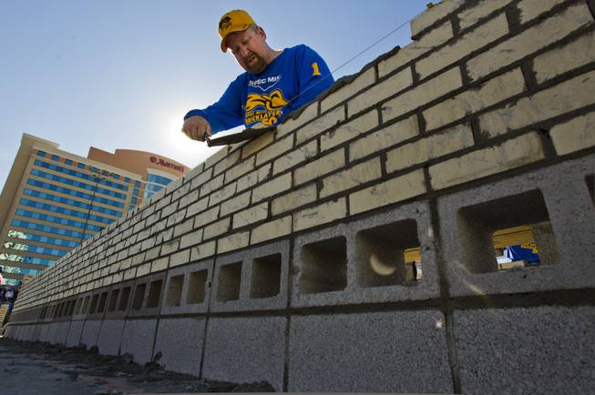 Last year's winner Fred Campbell from Limestone, Tenn., continues to build a solid wall during the Spec Mix "Bricklayer 500"   competition at the 40th anniversary of the World Of Concrete event outside the Las Vegas Convention Center on Wednesday, Jan. 22, 2014.