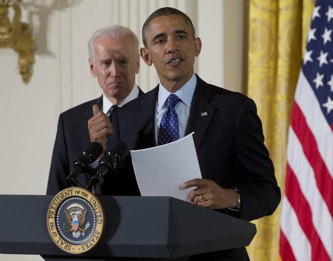 President Barack Obama, accompanied by Vice President Joe Biden, speaks in the East Room of the White House in Washington, Wednesday, Jan. 22, 2014, before the president signed a memorandum creating a task force to respond to campus rapes during an event for the Council on Women and Girls.