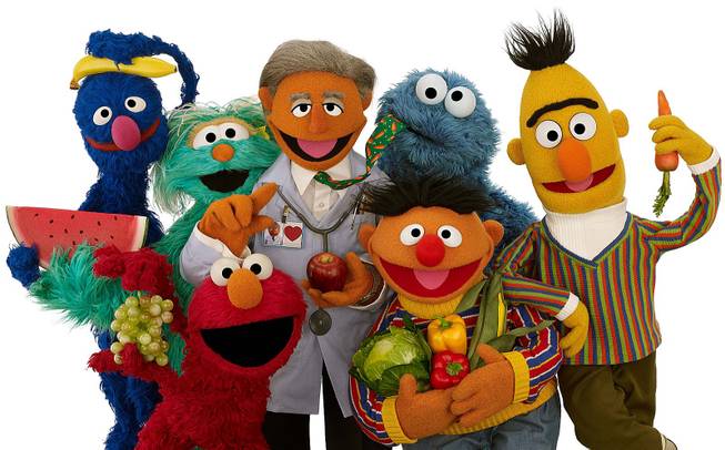 Muppet Dr. Ruster, center, is shown with, from left, Grover, Rosita, Elmo, Cookie Monster, Ernie and Bert. Dr. Valentin Fuster, a cardiologist at New York's Mount Sinai Hospital who Dr. Ruster is based on, teamed up with Sesame Street on a project to improve kids' health.