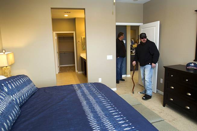 Army Sgt. Christopher Bales gets a look at the inside of his new home at the Coldwater Crossing subdivision in the Mountain's Edge master planned community Thursday Jan. 23, 2014. Bales was shocked to discover that the home was completely furnished. Pulte Homes, along with other companies, presented the home to Bales as part of Operation Finally Home," an organization which provides homes to veterans and the families of fallen servicemen.