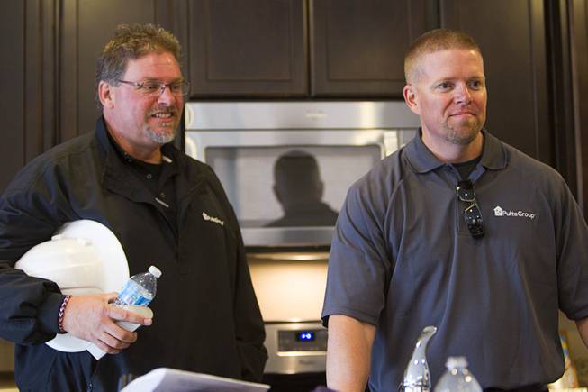 Alan Perkins, left, a Pulte Homes field manager, and Brandon Laughter, construction manager, listen as Army Sgt. Christopher Bales is interviewed in his new home at the Coldwater Crossing subdivision in the Mountain's Edge master planned community Thursday Jan. 23, 2014. Pulte Homes, along with other companies, presented the home to Bales as part of Operation Finally Home," an organization which provides homes to veterans and the families of fallen servicemen.