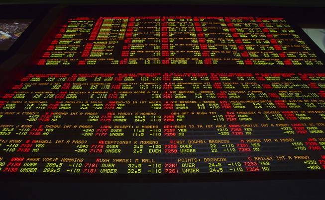 Super Bowl XLVIII proposition bets are posted on an electronic display board at the LVH Superbook on Thursday, Jan. 23, 2014.
