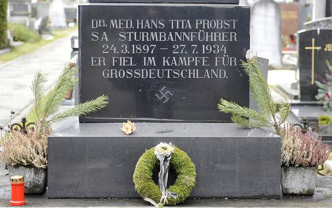This picture taken Tuesday, Jan. 21, 2014, shows a marble tombstone which is adorned by a swastika and the inscription “He died in the struggle for a Great Germany” at the central cemetery in Graz, Austria. 