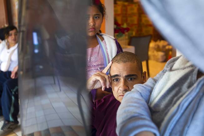 Francisco Diaz and his sister Jacqueline look over images taken of his brain in Mexicali, Mexico Saturday, Jan. 25, 2014. His niece Priscilla looks on at center-left. Francisco Diaz was born in Mexico but grew up in Las Vegas with a green card.