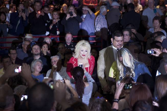 A Dolly Parton lookalike excites fans before Parton began her “Blue Smoke World Tour” stop at Star of the Desert Arena in Buffalo Bill’s on Saturday, Jan. 25, 2014, in Primm.