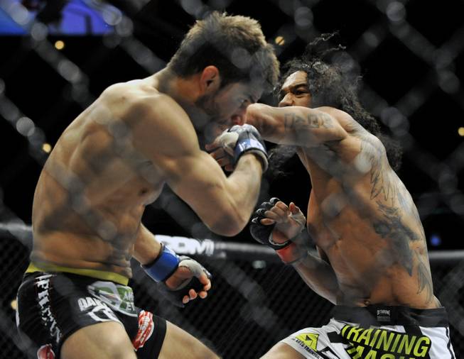 Benson Henderson right, punches Josh Thomson during the main event of the UFC mixed martial arts event in Chicago, Saturday, Jan., 25, 2014. 