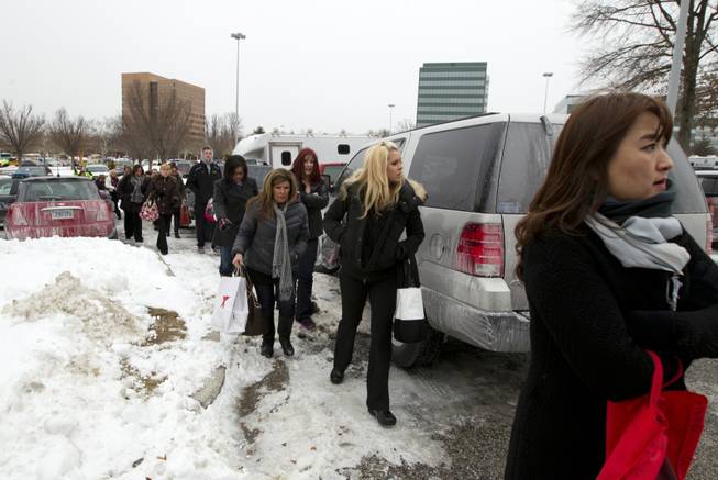 People are evacuated from the Mall in Columbia, Md., after a shooting Saturday Jan. 25, 2014, in Howard County, Md. Police say three people died, including the presumed gunman.