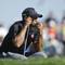 Photo: Tiger Woods waits his turn on the second green of 