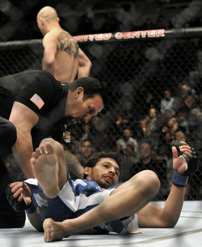 Adriano Martins lays on the canvas after being knocked out by Donald Cerrone during the lightweight bout of an UFC mixed martial arts match in Chicago, Saturday, Jan., 25, 2014.