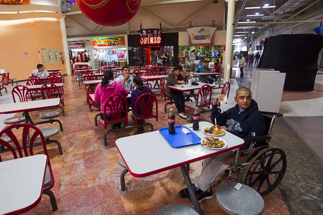 Francisco Diaz has lunch in a shopping mall in Mexicali, Mexico Sunday, Jan. 26, 2014. Diaz was born in Mexico but grew up in Las Vegas with a green card. Diaz was beaten and robbed after he was deported to Mexicali.