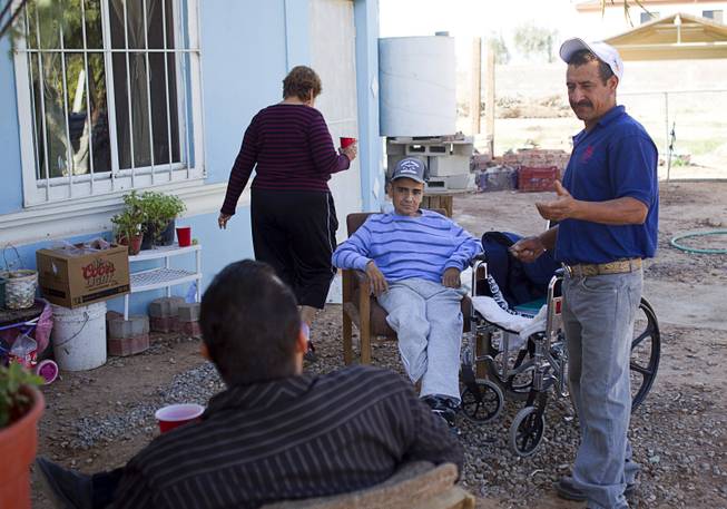 Francisco Diaz, center, at an elderly care home in Mexicali, Mexico Sunday, Jan. 26, 2014. Diaz is staying at the home while he is recovering from an robbery and assault that put him in a coma for three weeks. Diaz was born in Mexico but grew up in Las Vegas with a green card.