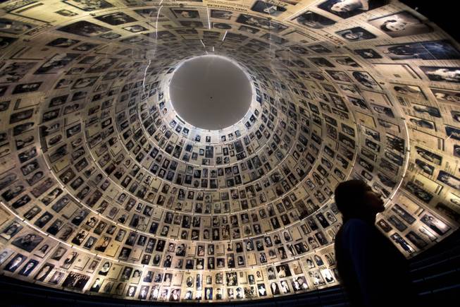 A visitor walks at the Hall of Names at the Yad Vashem Holocaust memorial in Jerusalem, ahead of the International Holocaust Remembrance Day, Sunday, Jan. 26, 2014. 