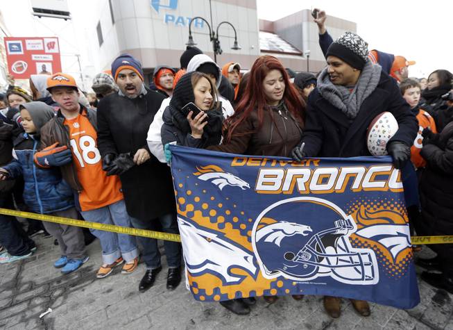 Denver Broncos fans wait for the players to arrive at the team hotel Sunday, Jan. 26, 2014, in Jersey City, N.J. The Broncos are scheduled to play the Seattle Seahawks in the NFL Super Bowl XLVIII football game Sunday, Feb. 2, in East Rutherford, N.J. 