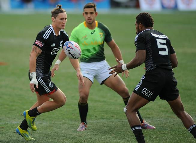 All Blacks 7s player Gillies Kaka, left, passes the ball to New Zealand teammate Lote Raikabula (5) during the Cup Final match of the Las Vegas 7's Rugby tournament at Sam Boyd Stadium on Sunday afternoon.