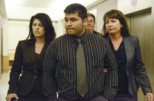 Erick Munoz, center, husband of Marlise Munoz, is escorted by attorneys as he walks to 96th District Court on Friday, Jan. 24, 2014, in Fort Worth, Texas. Marlise Munoz was 14 weeks pregnant when her husband found her unconscious Nov. 26, possibly due to a blood clot.
