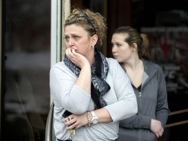 Restaurant general manager Heather Saffield and employee Chelsea Borschart, right, look outside their restaurant at the Mall in Columbia on Saturday, Jan. 25, 2014, in Columbia, Md.