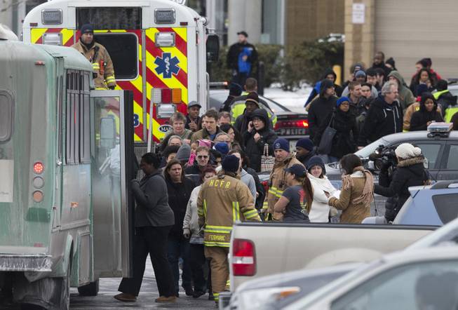 Mall shoppers are loaded onto shuttle busses and evacuated by police and rescue personnel after a shooting at The Mall in Columbia on Saturday, Jan. 25, 2014, in Columbia, Md. Police say three people died in a shooting at the mall in suburban Baltimore, including the presumed gunman. 