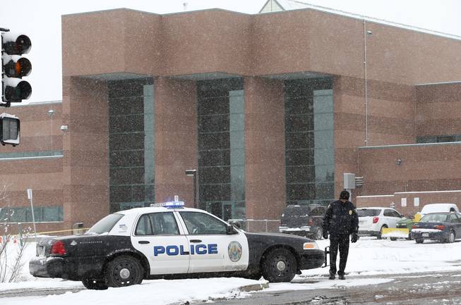 A police cruiser blocks the entrance to Standley Lake HIgh School, where classes were cancelled after an apparent suicide attempt by a student, in Westminster, Colo., Monday, Jan. 27, 2014. Police say a 16-year-old boy was critically injured after setting himself on fire at the suburban Denver high school.