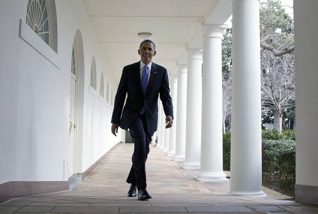 President Barack Obama walks along the Colonnade at the White House in Washington, Tuesday, Jan. 28, 2014, hours before giving his State of the Union address before a joint session of Congress. 