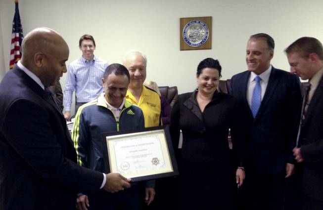 Taxicab Authority Administrator Charles Harvey presents a certificate to Yellow Checker Star cab driver Gerardo Gamboa, who discovered $300,000 in a bag in his cab and returned it to its owner last month. YCS manager Bill Shranko and authority board members Joshua Miller, rear, and Chairman Ileana Drobkin, Dean Collins and Joseph Hardy Jr. were also on hand for the presentation Jan. 28, 2014. 