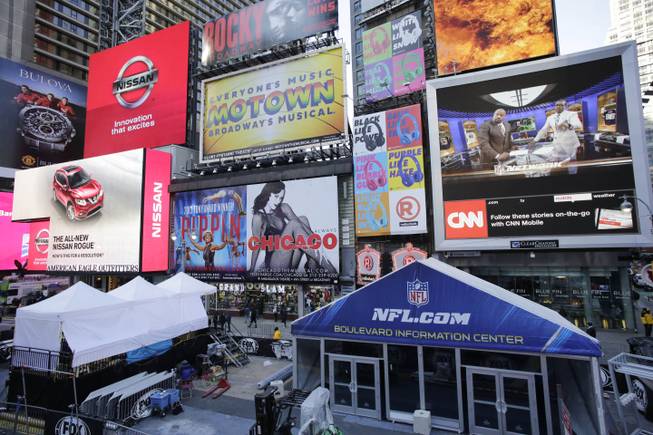 An information tent, lower right, is in place for Super Bowl Boulevard in New York's Times Square, Tuesday, Jan. 28, 2014. Thirteen blocks of midtown Manhattan have been converted into a temporary festival space leading up to the National Football League's championship game between the Seattle Seahawks and the Denver Broncos on Sunday, Feb. 2, in East Rutherford, N.J.