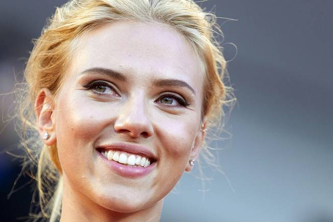 Actress Scarlett Johansson poses for photographers on the red carpet for the screening of the film "Under The Skin" at the 70th edition of the Venice Film Festival in Venice, Italy, Sept. 3, 2013.
