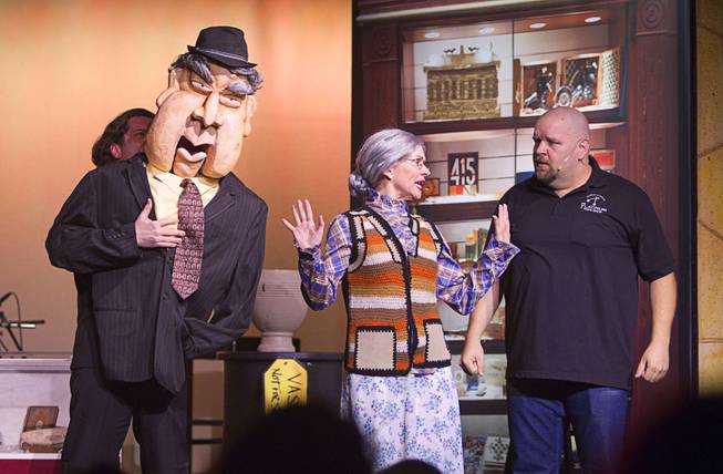 Old Fart (Enoch Scott), left, and Slick Garrison (Sean Critchfield), right talk with a school teacher (Anita Bean)during a performance of "Pawn Shop Live!" at the Golden Nugget Thursday, Jan. 30, 2014. The production show is a parody based on the story of Gold & Silver Pawn, home of the History Channel's Pawn Stars television series.