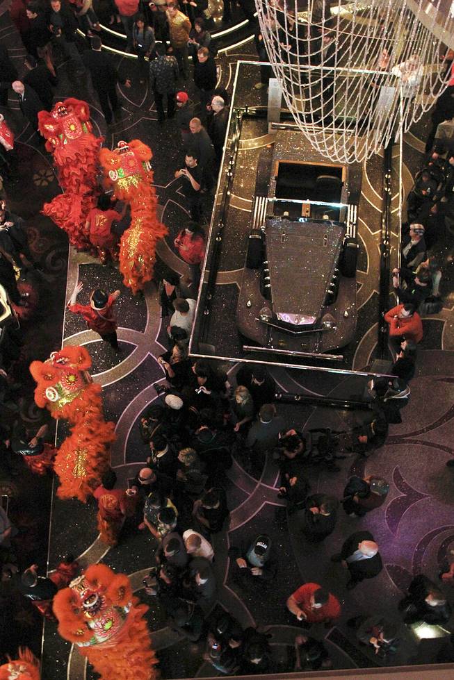 Dancers make their way past a Liberace car on display during a "Dotting of the Eyes" ceremony as the Cosmopolitan marks the Year of the Horse Saturday, Feb. 1, 2014.