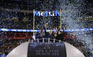 Seattle Seahawks head coach Pete Carroll holds the Vince Lombardi Trophy as he celebrates after the NFL Super Bowl XLVIII football game against the Denver Broncos Sunday, Feb. 2, 2014, in East Rutherford, N.J. The Seahawks won 43-8. (AP Photo/Matt Slocum)
